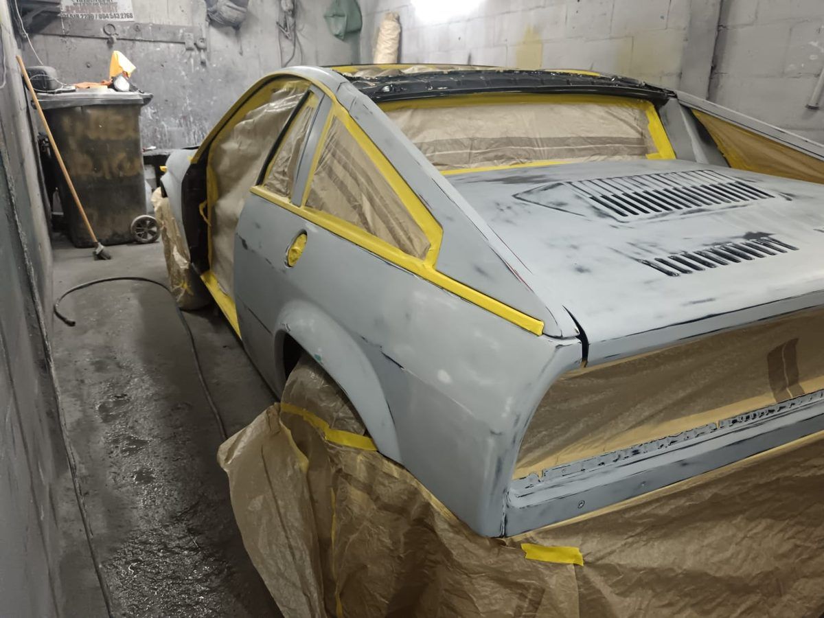 Lancia Beta shell in grey primer during restoration