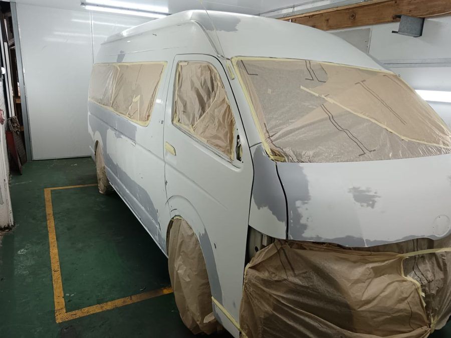 Toyota Quantum minibus in the paint booth before respray