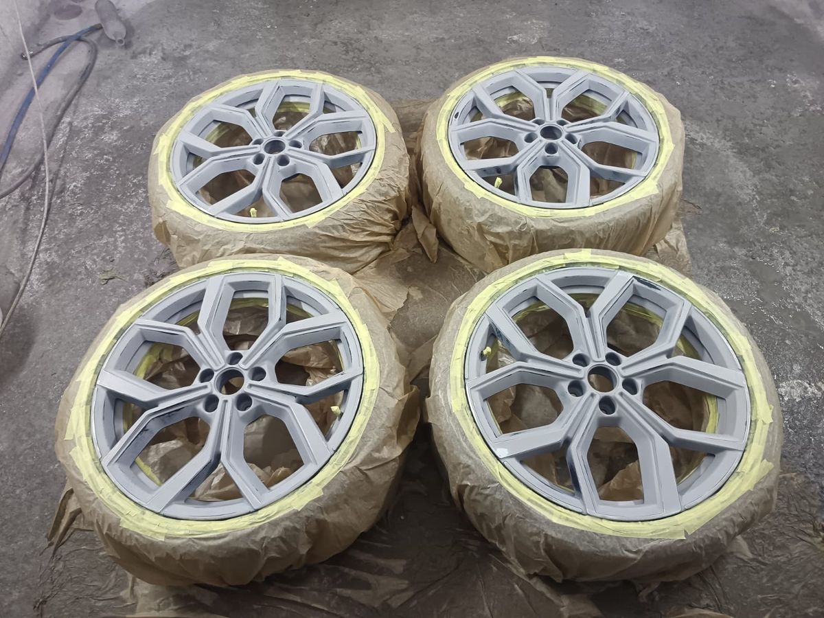 Alloy wheels masked and primed before respray